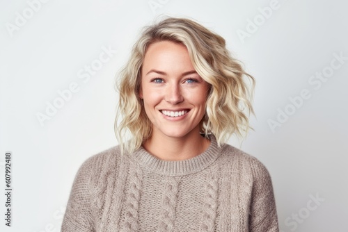 Portrait of a happy young woman smiling at camera over white background