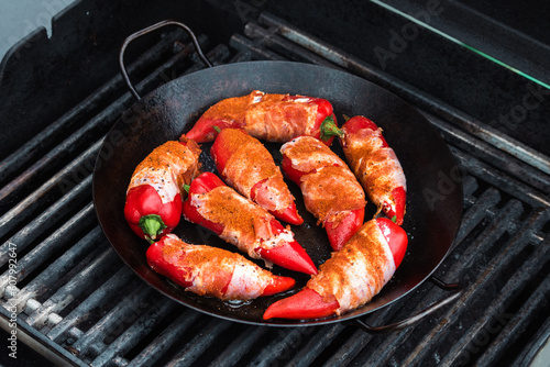 Paprika filled with cream cheese and bacon on a cast-iron frying pan / Cast iron pan / cast iron skillet / Roasted Paprika / Paprika / Bacon / Grilled / BBQ 