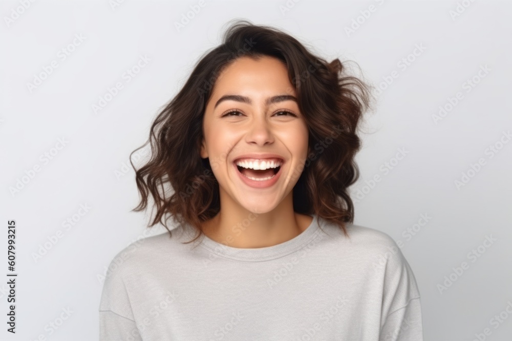 Close up portrait of a happy young woman laughing and looking at camera isolated over white background Close up portrait of a happy young woman laughing and looking at camera isolated over white background