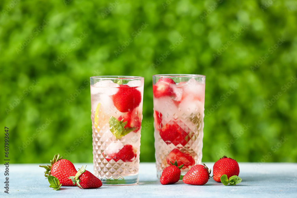 Glasses of strawberry lemonade on blue table outdoors Glasses of strawberry lemonade on blue table outdoors