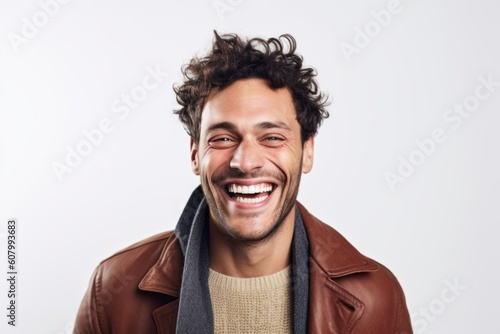 Portrait of a happy young man laughing at camera over white background
