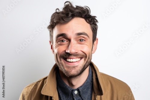 Portrait of a young man smiling at the camera on a white background © Robert MEYNER