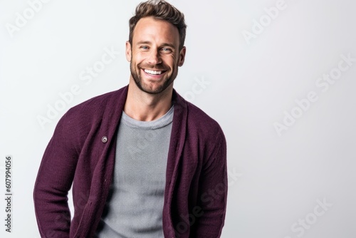 Portrait of a smiling handsome man standing isolated on a white background