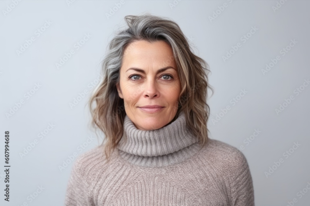 Close up portrait of a beautiful middle-aged woman with gray hair in a sweater on a white background Close up portrait of a beautiful middle-aged woman with gray hair in a sweater on a white background