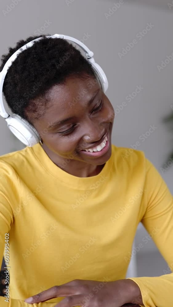 Young adult woman attending a video call or webinar on laptop. Business and remote work concept. Vertical screen footage for phone. Young adult woman attending a video call or webinar on laptop. Business and remote work concept. Vertical screen footage for phone.