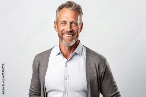 Portrait of a handsome mature man smiling and looking at camera isolated over white background