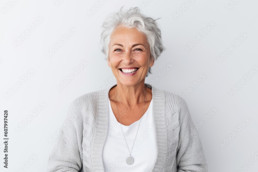 Portrait of a happy senior woman smiling at camera over white background Portrait of a happy senior woman smiling at camera over white background