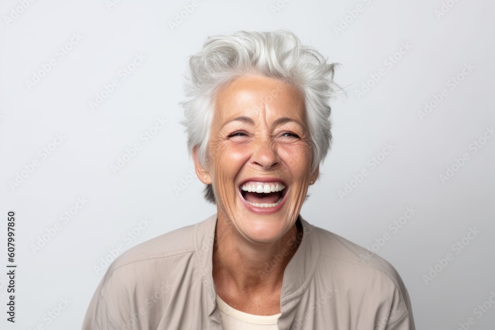 Portrait of a happy senior woman laughing on a white background. Portrait of a happy senior woman laughing on a white background.