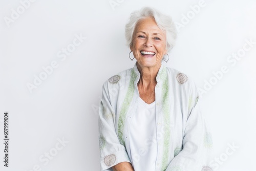 Lifestyle portrait photography of a pleased woman in her 60s that is placed against a white background . Generative AI photo