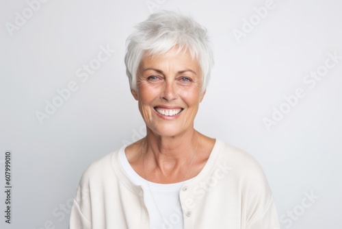 Portrait of a happy senior woman looking at camera over white background
