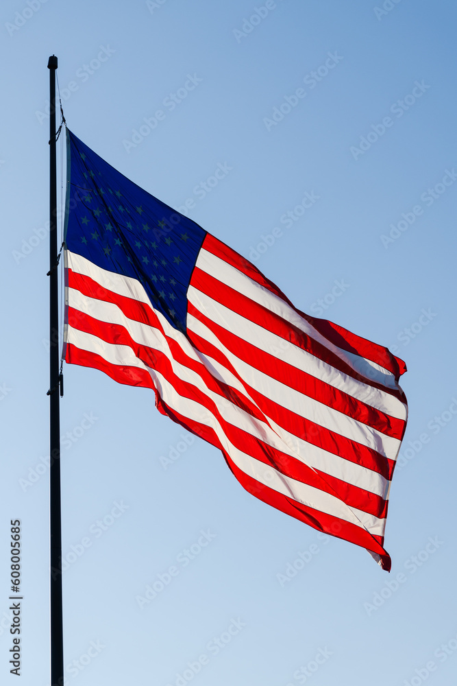 Fototapeta premium United States of America Stars and Stripes national flag fluttering on pole