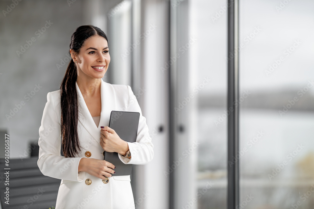 Businesswoman holding tablet in modern office Businesswoman holding tablet in modern office