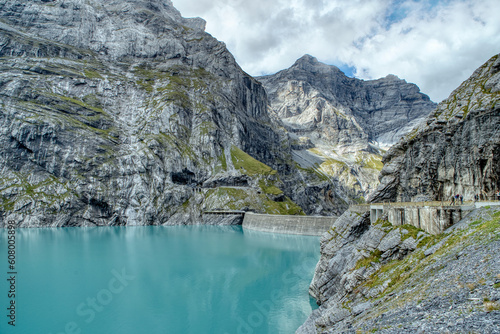View of the Limmernsee dam in the canton of Glarus. Hiking high above the mountain lake in the Alps. Limmernsee Lake, Glarus, Switzerland
