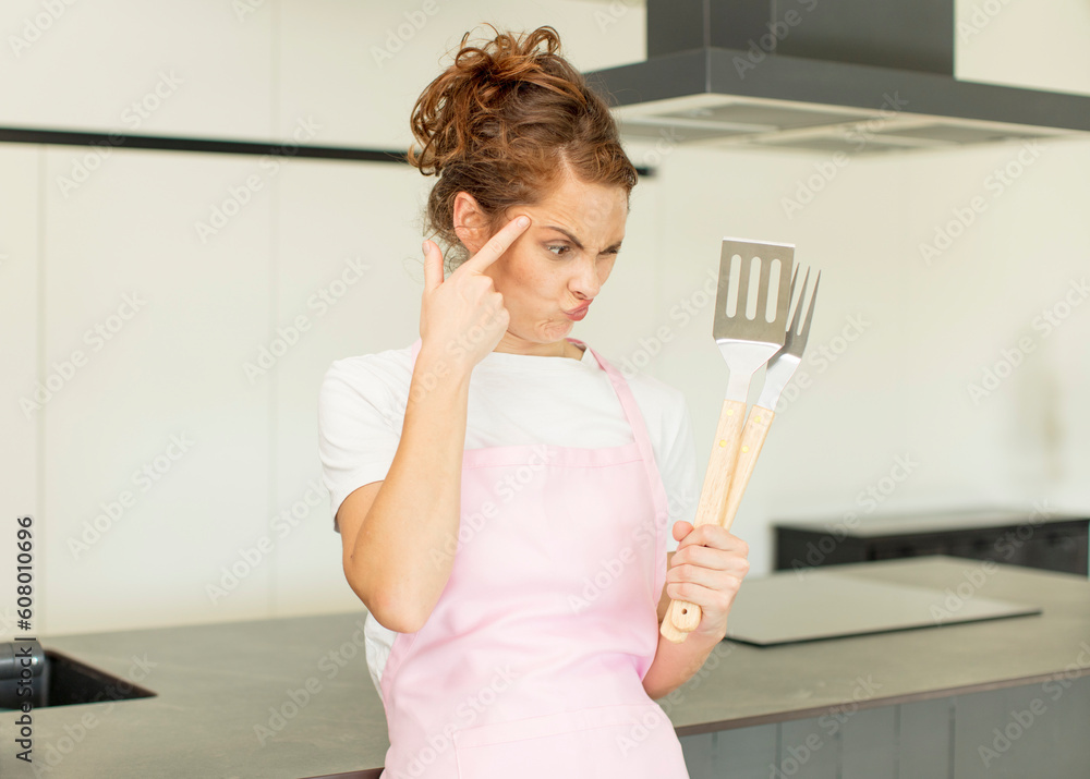 young pretty woman looking surprised, realizing a new thought, idea or concept. home chef concept young pretty woman looking surprised, realizing a new thought, idea or concept. home chef concept