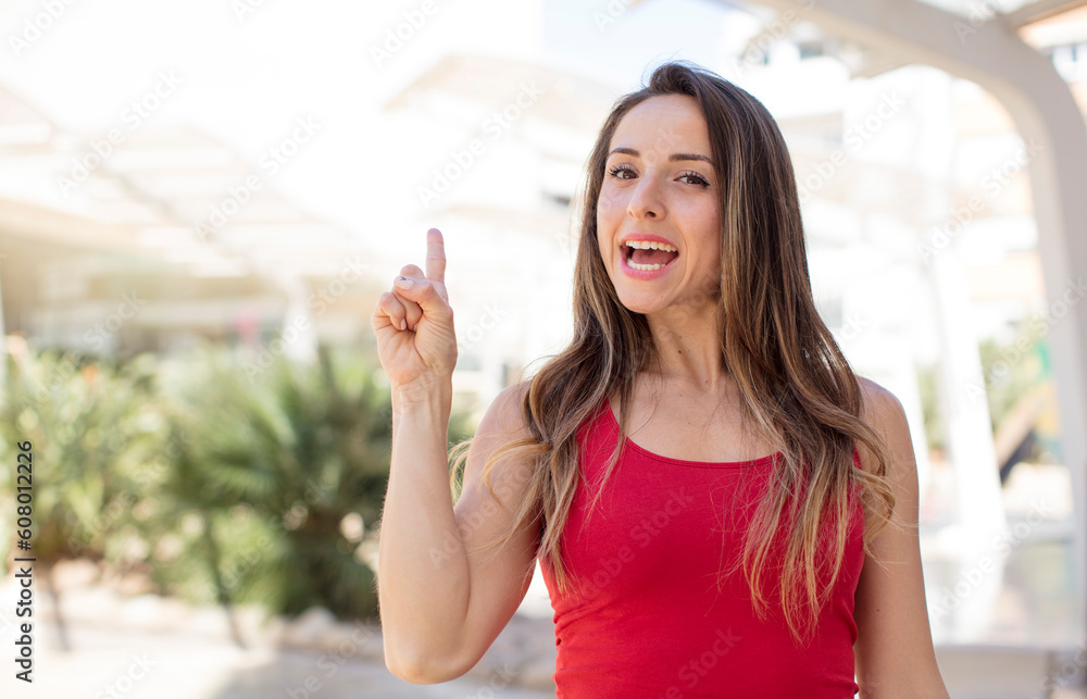 pretty woman feeling like a happy and excited genius after realizing an idea, cheerfully raising finger, eureka! pretty woman feeling like a happy and excited genius after realizing an idea, cheerfully raising finger, eureka!