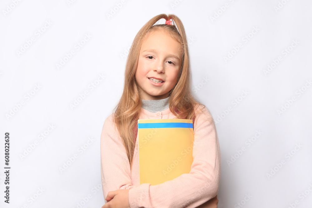 Happy little girl with magazine on white background Happy little girl with magazine on white background