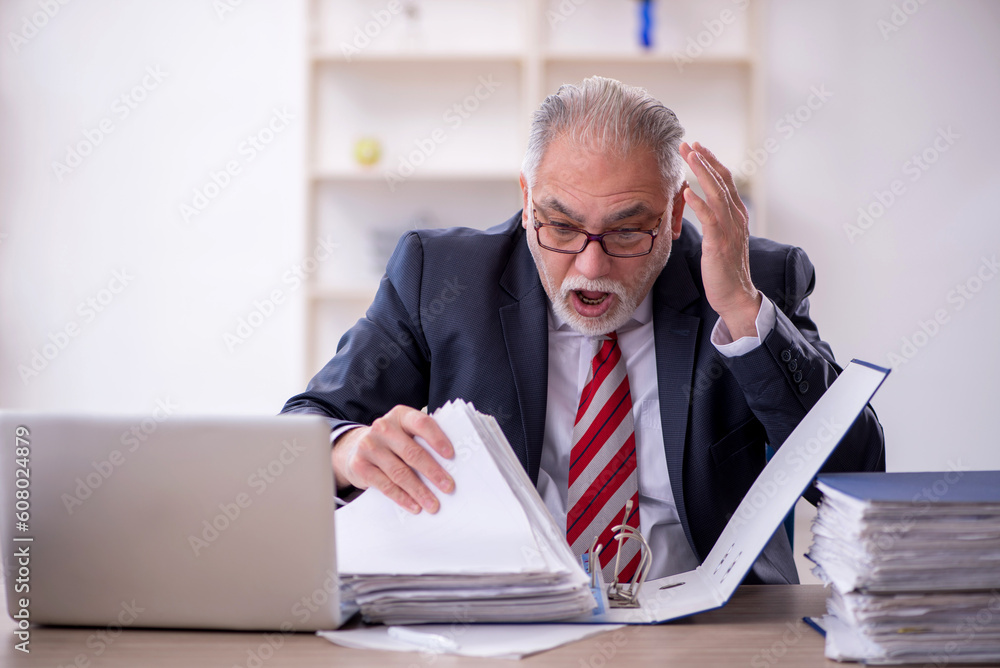 Old male employee and too much work in the office Old male employee and too much work in the office