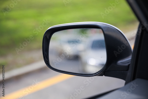 Car side mirror represents reflection, awareness, safety, and the visual extension of the driver's field of view © Your Hand Please