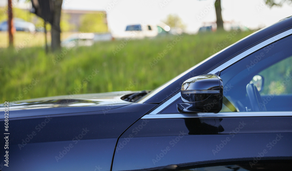 Car side mirror represents reflection, awareness, safety, and the visual extension of the driver's field of view