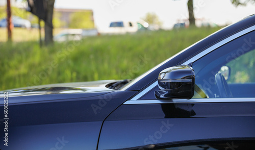 Car side mirror represents reflection, awareness, safety, and the visual extension of the driver's field of view © Your Hand Please