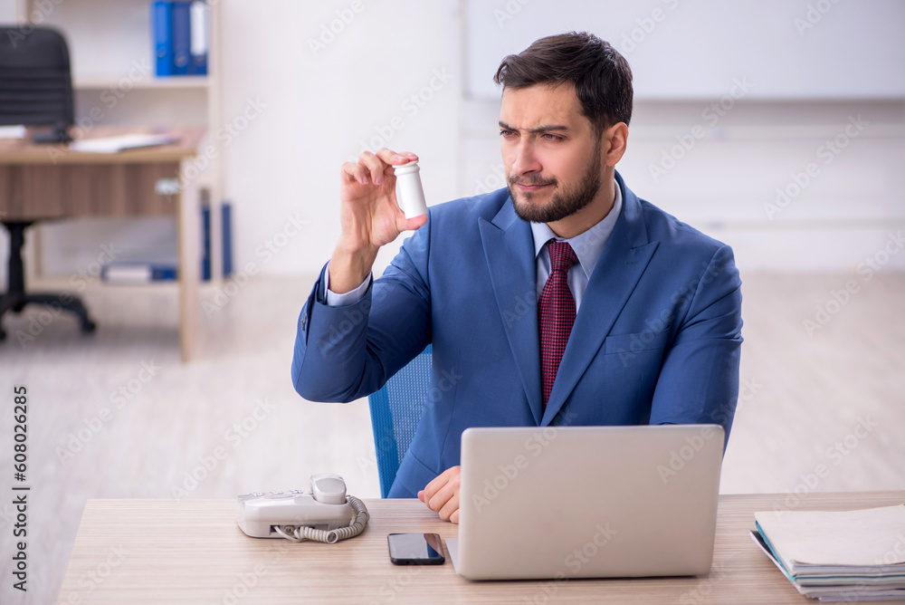 Young male employee feeling bad at workplace Young male employee feeling bad at workplace