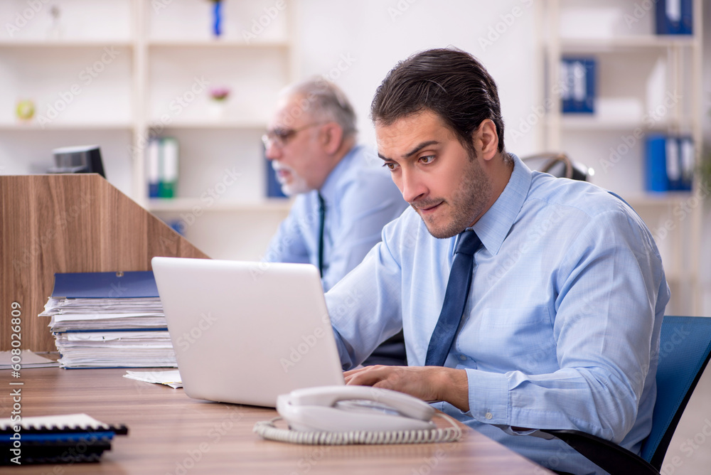 Two male colleagues working in the office Two male colleagues working in the office