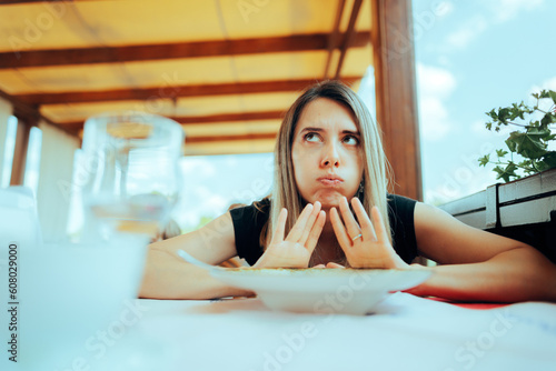 Woman Refusing to Eat her Meal Feeling Full. Customer sending the dish back unhappy with the serving 
