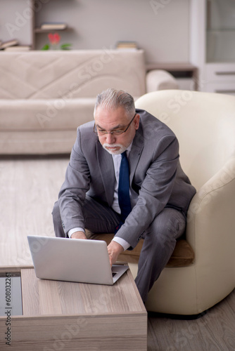 Old male boss working from home during pandemic