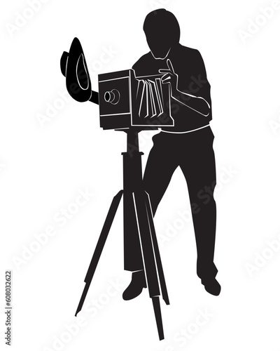 Silhouette of the photographer with the old camera on a white background