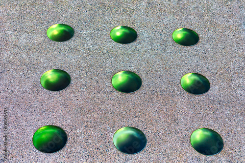 Glass circles in the stone floor . Green circles in a row