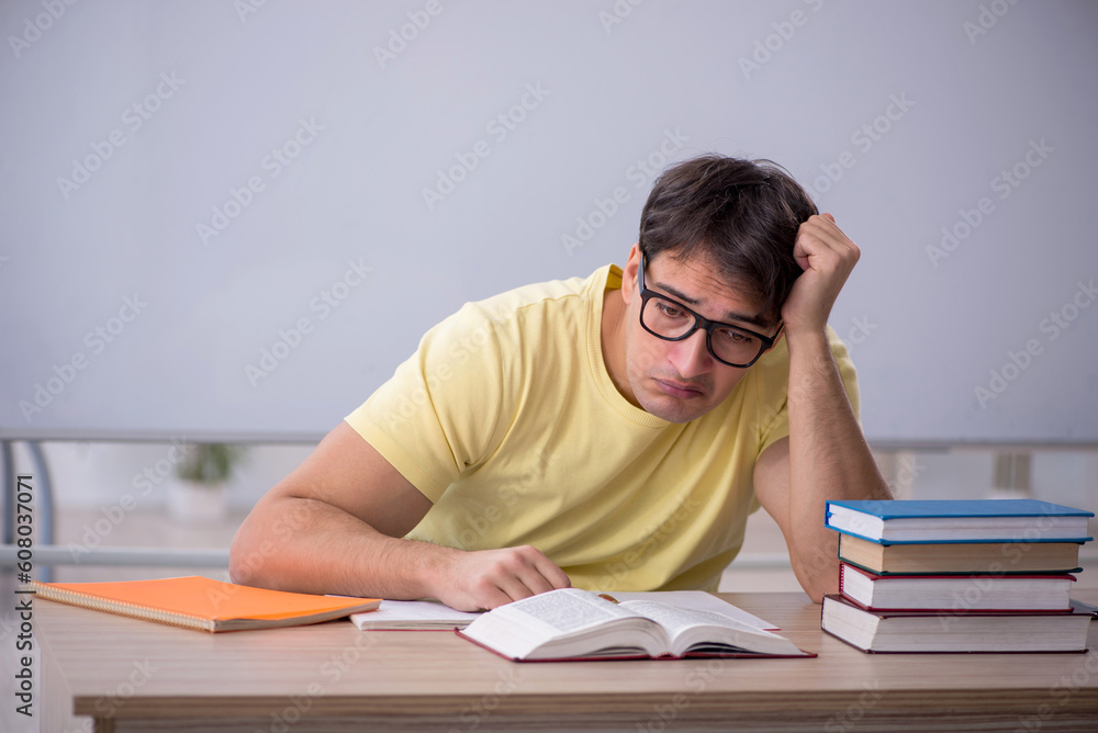Young male student sitting in the classroom Young male student sitting in the classroom
