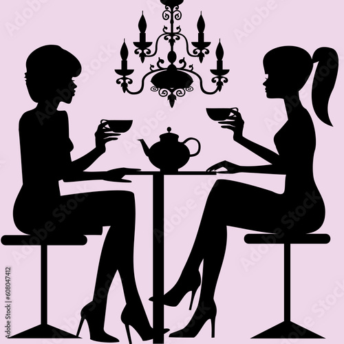 Silhouettes of two women sitting down talking and drinking tee or coffee, background with old chandelier.