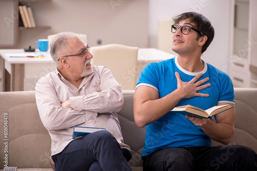 Young male student and his grandfather at home