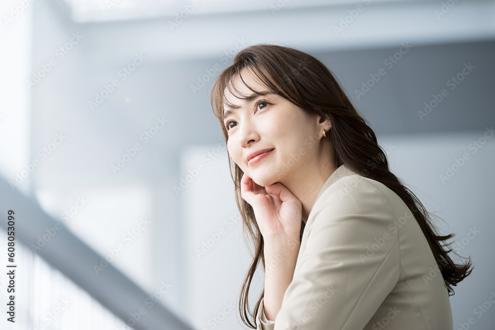 © kapinon - Image of a handsome woman in a cool suit working in an office looking at her goals and future. For job change and recruitment. © kapinon - Image of a handsome woman in a cool suit working in an office looking at her goals and future. For job change and recruitment.