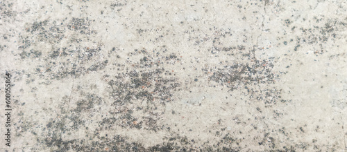 The texture of the gray cement wall on a gray background, taken at close range