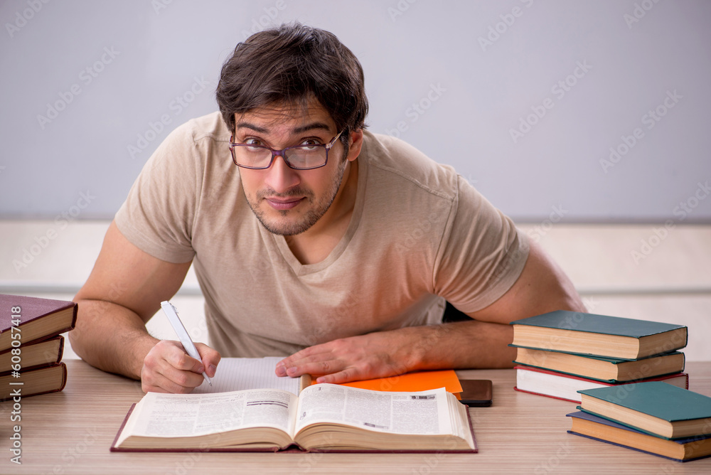 Young male student sitting in the classroom Young male student sitting in the classroom