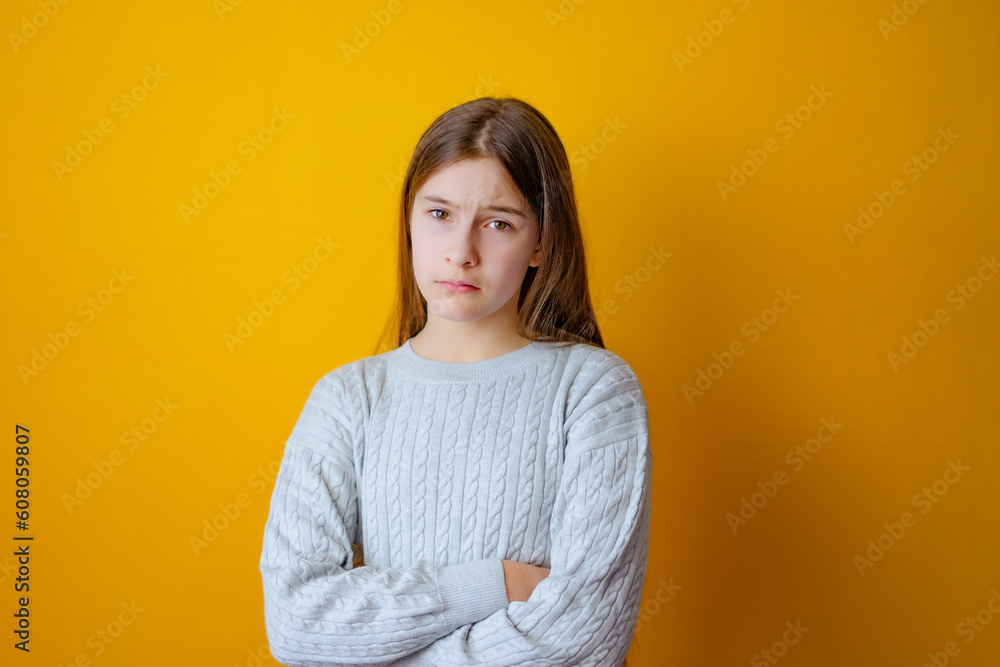 Serious little girl with cross arms on chest and look determined Serious little girl with cross arms on chest and look determined