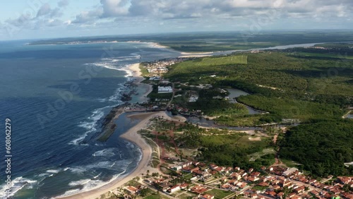 Rotating extreme wide aerial drone landscape shot of the tropical  coastline of Northeastern Brazil over the beach town of Sibauma in Tibau do Sul, Rio Grande do Norte, Brazil on a summer day photo