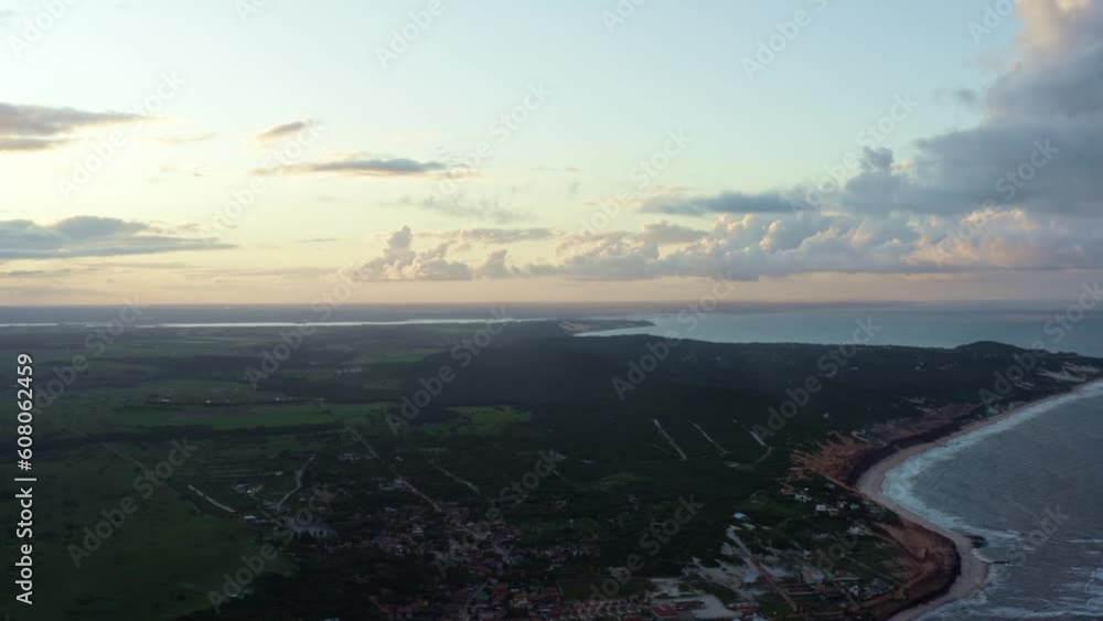 Right trucking aerial drone wide landscape shot of the tropical Sibauma coastline in Tibau do Sul, Rio Grande do Norte, Brazil near the tourist town of Pipa during a warm summer evening sunset Right trucking aerial drone wide landscape shot of the tropical Sibauma coastline in Tibau do Sul, Rio Grande do Norte, Brazil near the tourist town of Pipa during a warm summer evening sunset