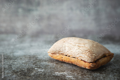 Ciabatta bread on a vintage dark floor