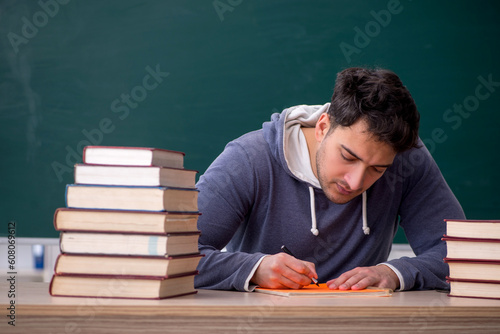 Young male student sitting in the classroom