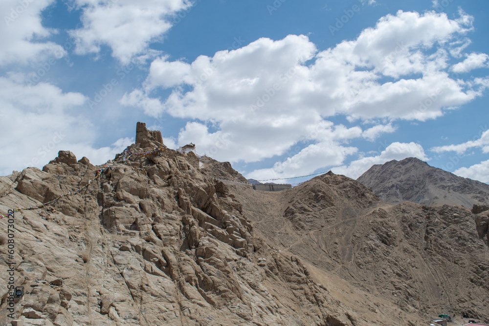 Fototapeta premium The barren landscape of Leh, Ladakh. Landscape view of rocky land surrounded by Himalayas Dramatic clouds. 