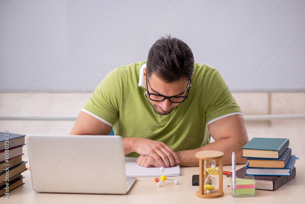 Young male student preparing for exams in the classroom Young male student preparing for exams in the classroom