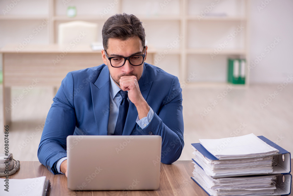 Young male employee working in the office Young male employee working in the office
