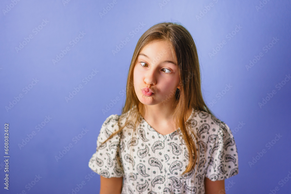 Cute girl builds funny face and fools around Cute girl builds funny face and fools around