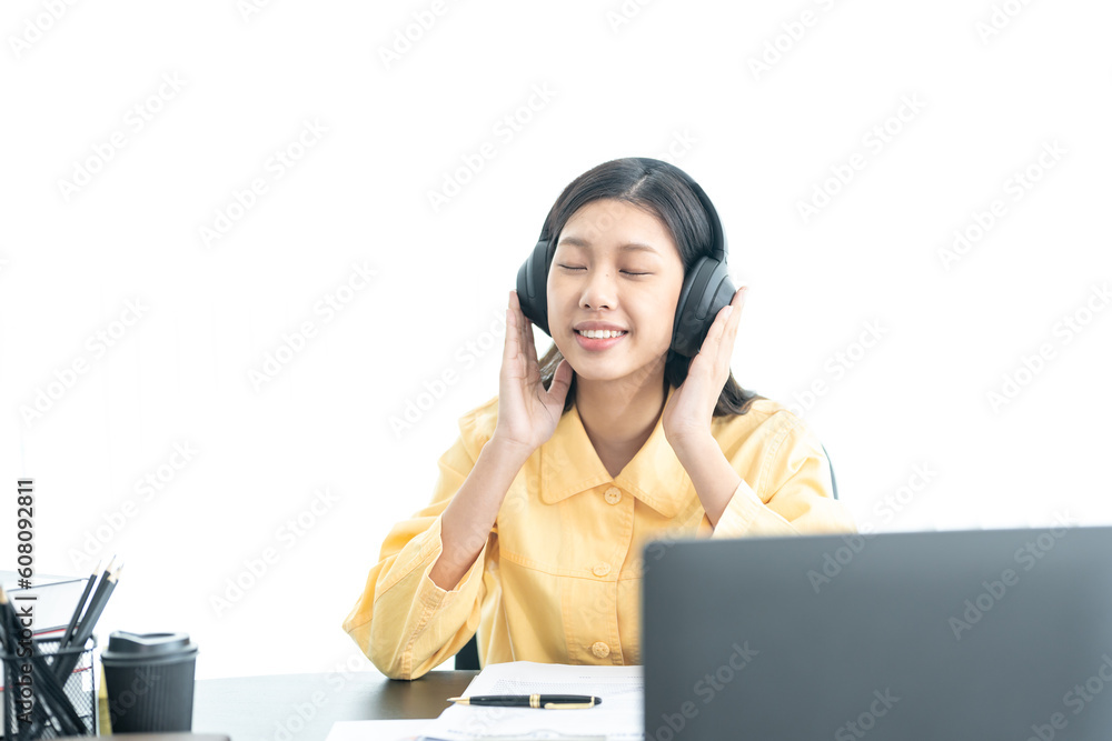 Attractive young Asian business woman relaxing from work during break listening to music and having fun. on white background Attractive young Asian business woman relaxing from work during break listening to music and having fun. on white background