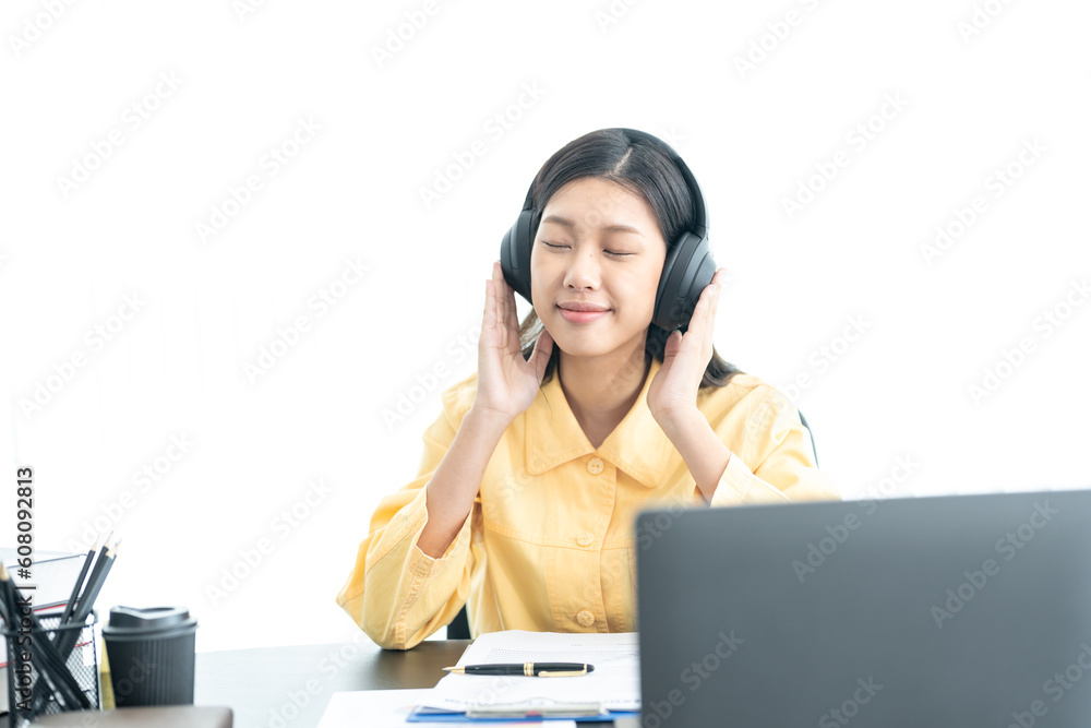 Attractive young Asian business woman relaxing from work during break listening to music and having fun. on white background Attractive young Asian business woman relaxing from work during break listening to music and having fun. on white background