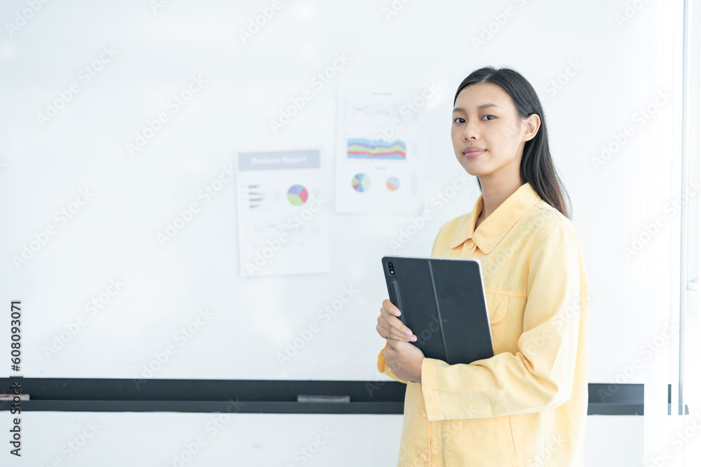 Confident businesswoman holding tablet and smiling at the camera, in meeting room on white background. Confident businesswoman holding tablet and smiling at the camera, in meeting room on white background.