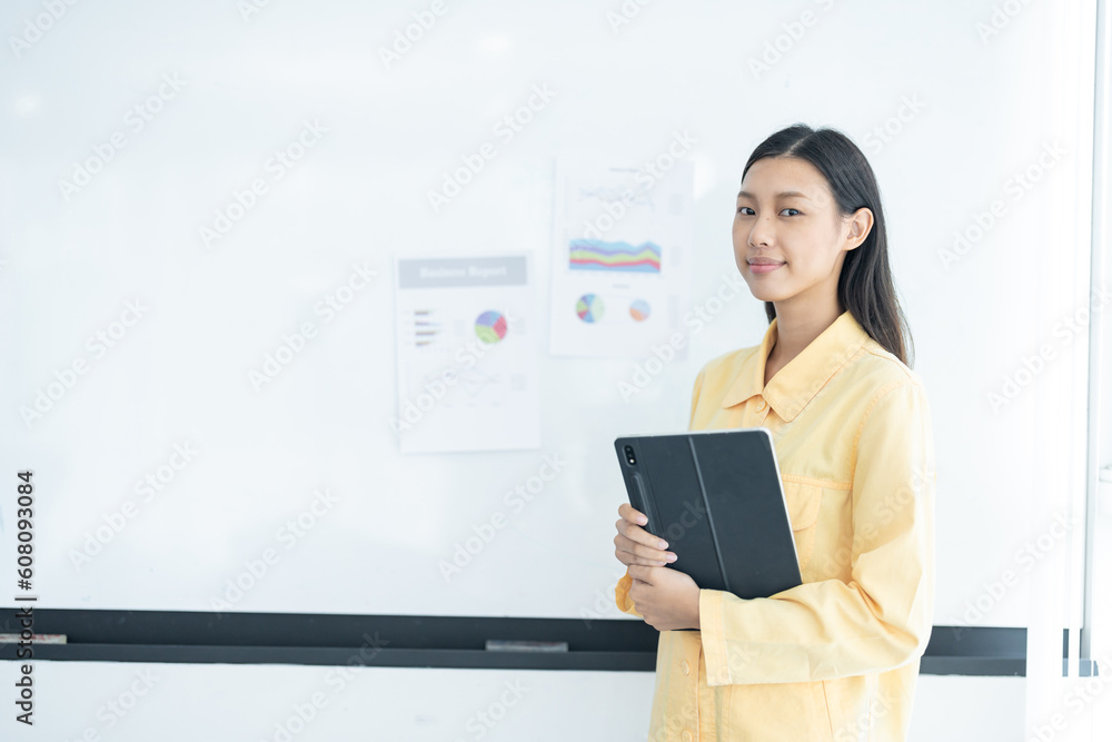 Confident businesswoman holding tablet and smiling at the camera, in meeting room on white background. Confident businesswoman holding tablet and smiling at the camera, in meeting room on white background.