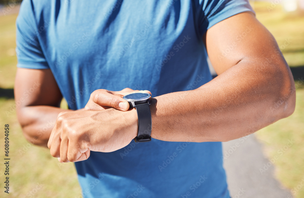 Fitness, stopwatch and man with a watch outdoor for training or running progress at park. Smartwatch on arm of athlete person in nature with time to exercise, start run and check performance goals